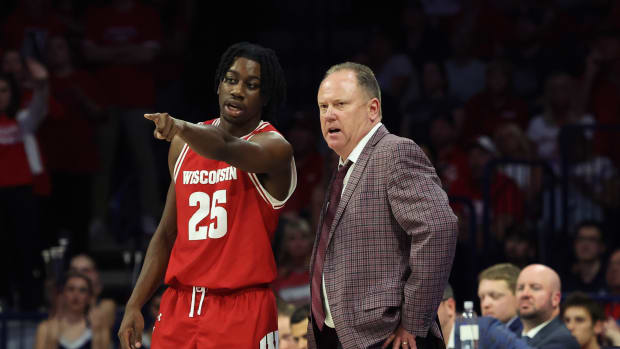 Dec 9, 2023; Tucson, Arizona, USA; Wisconsin Badgers guard John Blackwell (25) talks to Wisconsin Badgers head coach Greg Gard during the second half at McKale Center. Mandatory Credit: Zachary BonDurant-USA TODAY Sports  